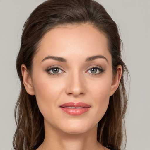 Joyful white young-adult female with long  brown hair and brown eyes