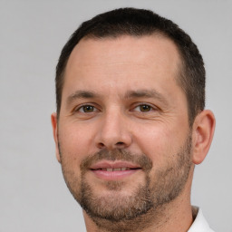 Joyful white adult male with short  brown hair and brown eyes