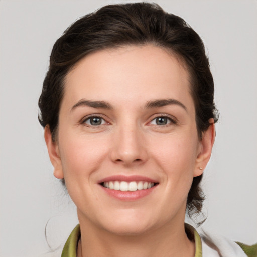 Joyful white young-adult female with medium  brown hair and grey eyes