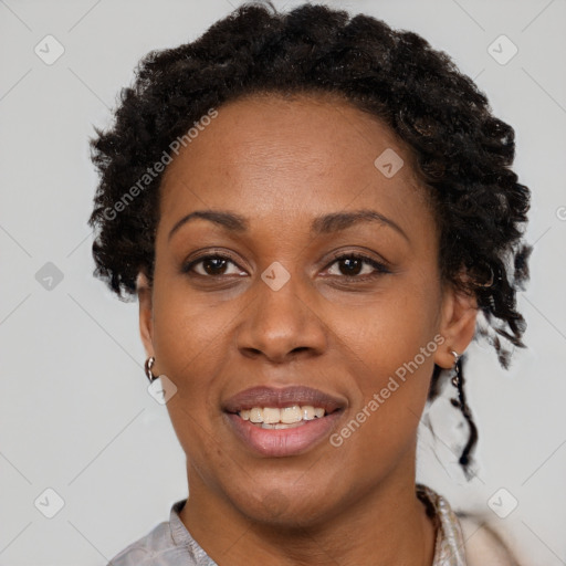 Joyful black adult female with short  brown hair and brown eyes