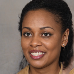 Joyful black young-adult female with long  brown hair and brown eyes