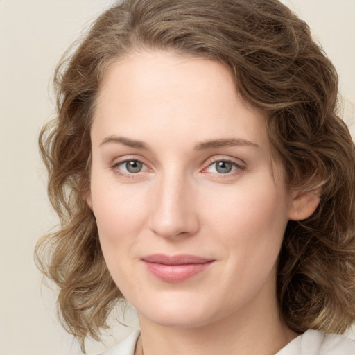 Joyful white young-adult female with medium  brown hair and green eyes