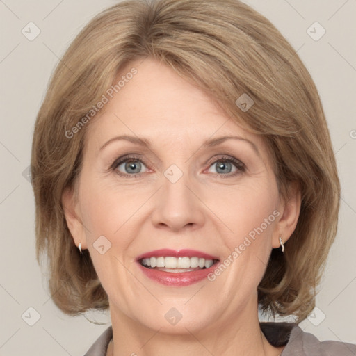 Joyful white adult female with medium  brown hair and grey eyes