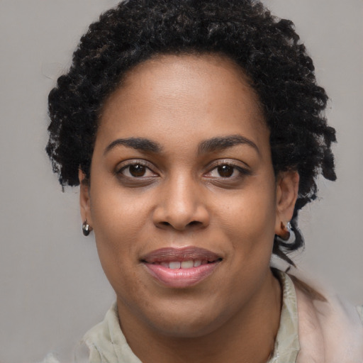 Joyful black young-adult female with short  brown hair and brown eyes