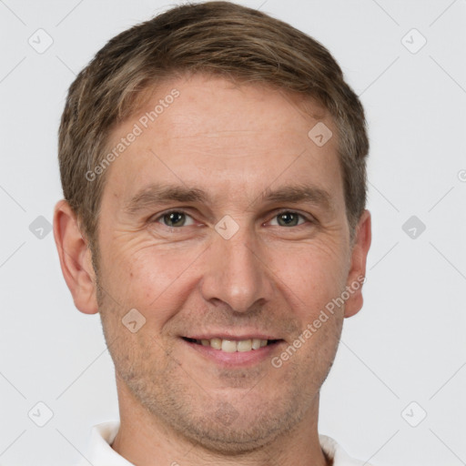 Joyful white adult male with short  brown hair and brown eyes