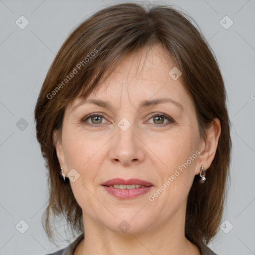 Joyful white adult female with medium  brown hair and grey eyes