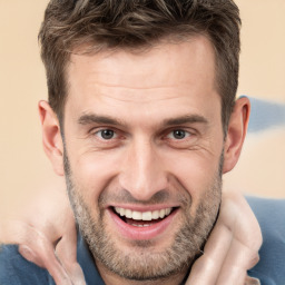 Joyful white adult male with short  brown hair and brown eyes