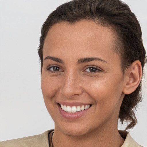 Joyful white young-adult female with short  brown hair and brown eyes