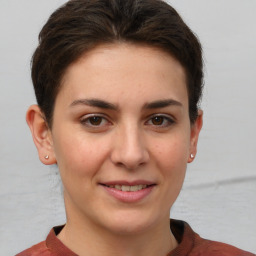 Joyful white young-adult female with short  brown hair and brown eyes