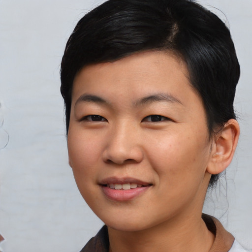 Joyful asian young-adult female with short  black hair and brown eyes