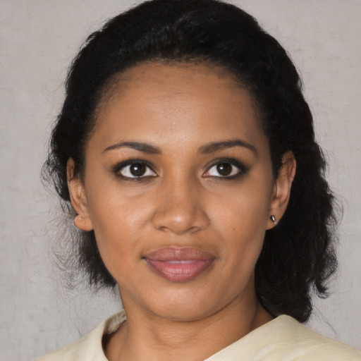 Joyful black young-adult female with medium  black hair and brown eyes