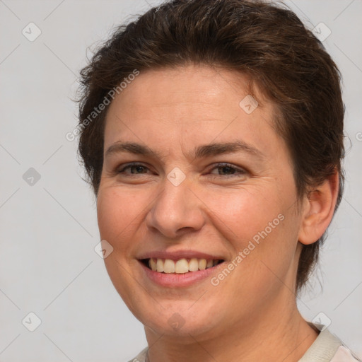 Joyful white adult female with short  brown hair and brown eyes