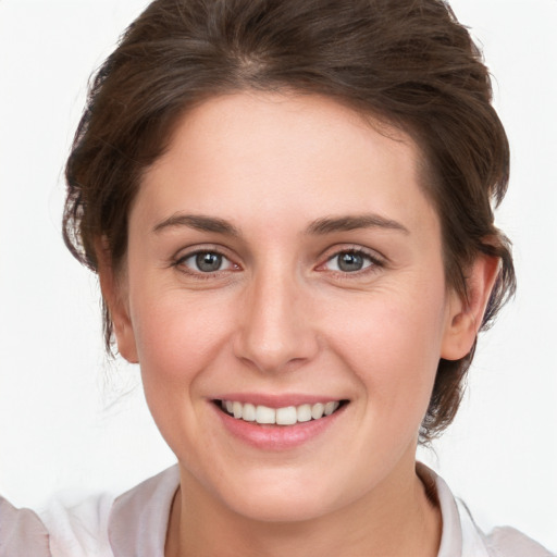 Joyful white young-adult female with medium  brown hair and grey eyes