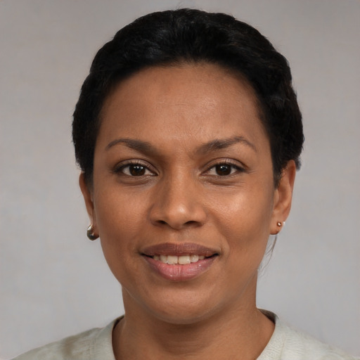 Joyful latino young-adult female with short  black hair and brown eyes