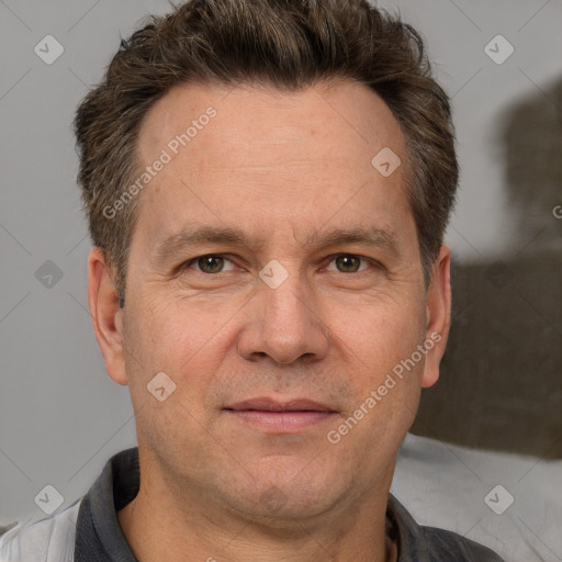 Joyful white adult male with short  brown hair and grey eyes