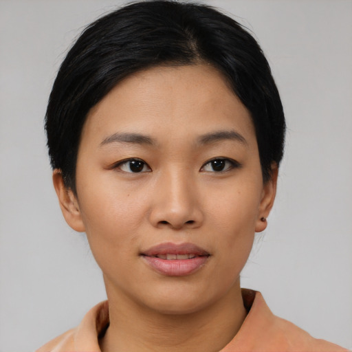 Joyful asian young-adult female with short  black hair and brown eyes