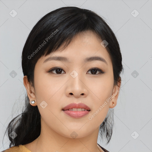 Joyful asian young-adult female with medium  black hair and brown eyes