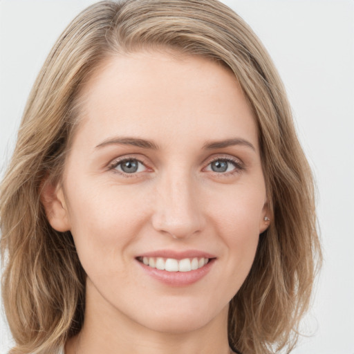 Joyful white young-adult female with long  brown hair and blue eyes