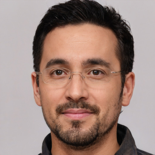 Joyful white adult male with short  black hair and brown eyes