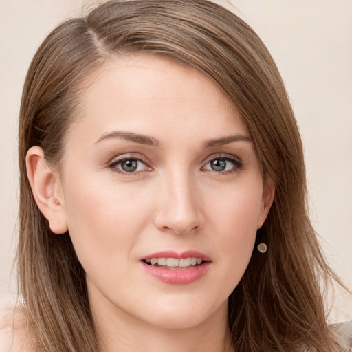 Joyful white young-adult female with long  brown hair and grey eyes