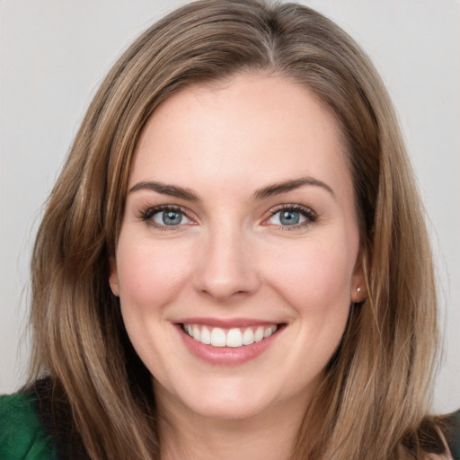 Joyful white young-adult female with medium  brown hair and green eyes