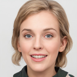 Joyful white young-adult female with medium  brown hair and blue eyes