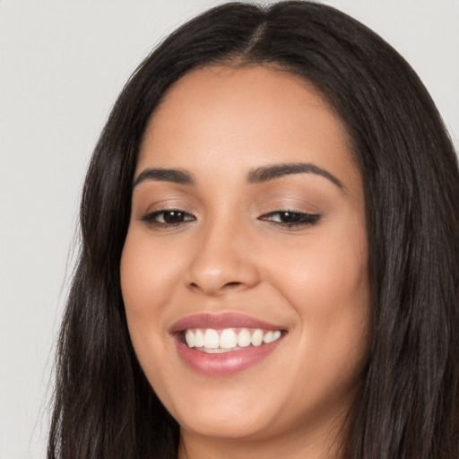 Joyful white young-adult female with long  black hair and brown eyes