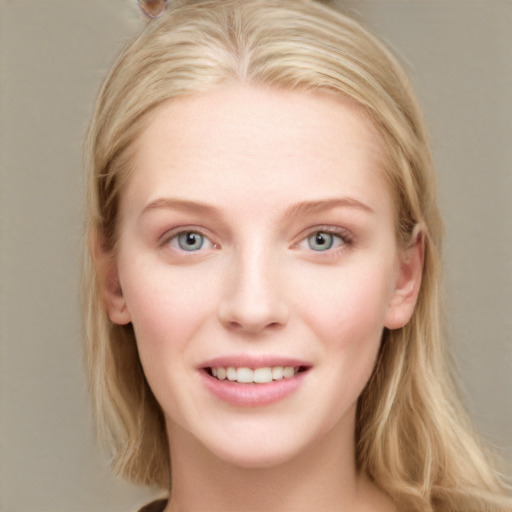 Joyful white young-adult female with long  brown hair and blue eyes