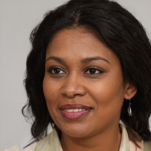 Joyful black young-adult female with medium  brown hair and brown eyes