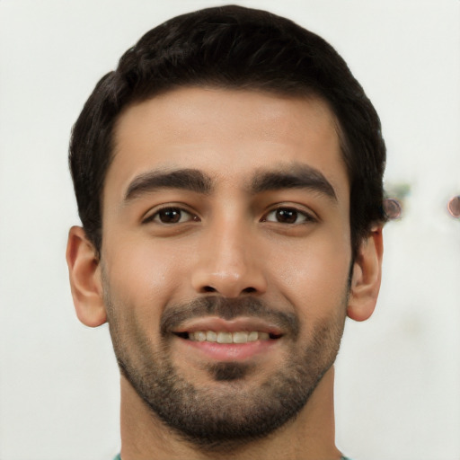 Joyful latino young-adult male with short  black hair and brown eyes