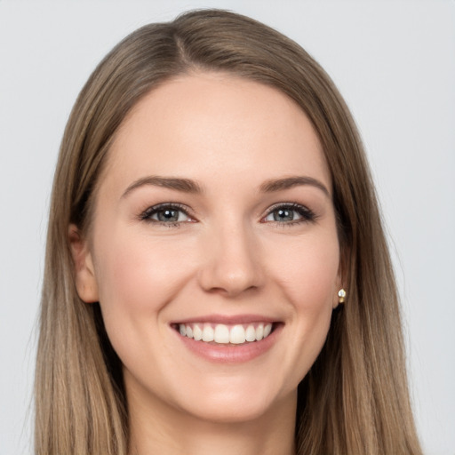 Joyful white young-adult female with long  brown hair and grey eyes