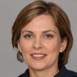 Joyful white adult female with medium  brown hair and grey eyes