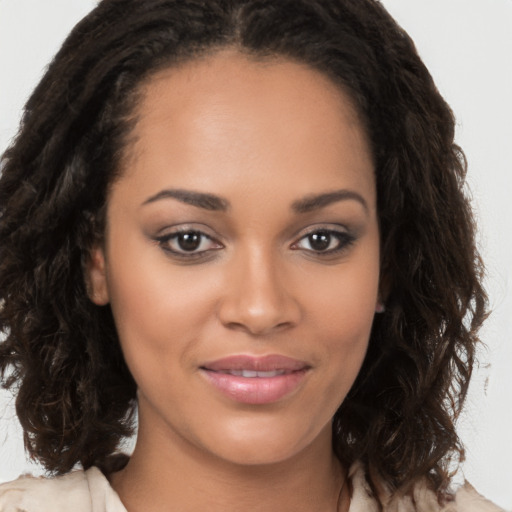 Joyful latino young-adult female with long  brown hair and brown eyes