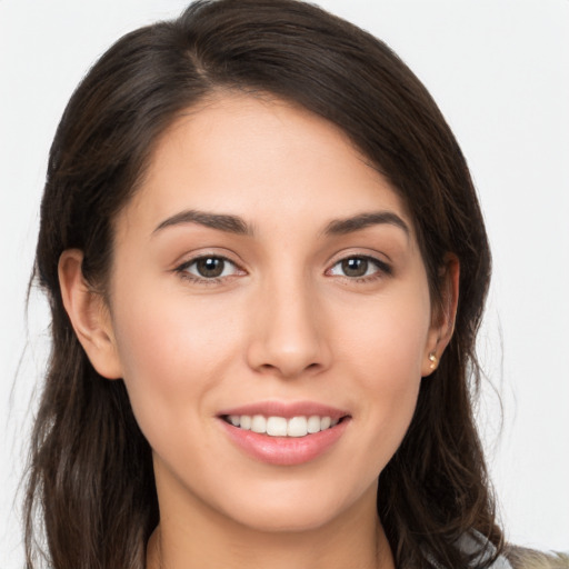 Joyful white young-adult female with long  brown hair and brown eyes