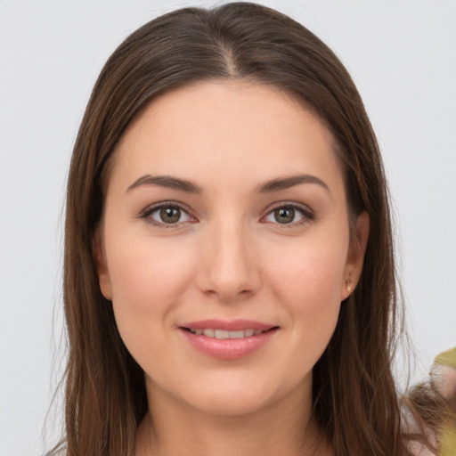 Joyful white young-adult female with long  brown hair and brown eyes