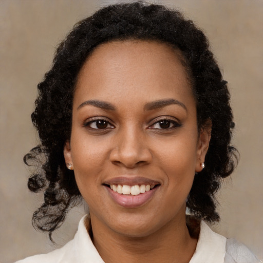 Joyful black young-adult female with medium  black hair and brown eyes