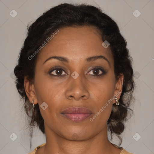Joyful black adult female with medium  brown hair and brown eyes
