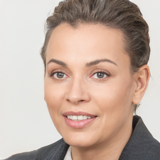 Joyful white young-adult female with short  brown hair and brown eyes