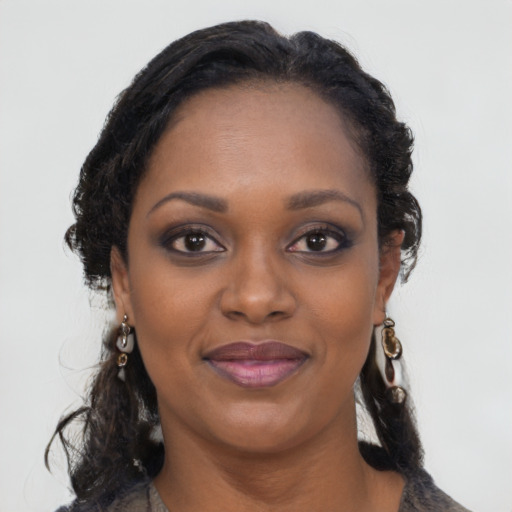 Joyful black young-adult female with medium  brown hair and brown eyes