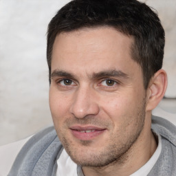 Joyful white adult male with short  brown hair and brown eyes