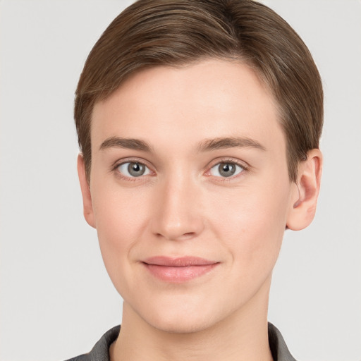 Joyful white young-adult female with short  brown hair and grey eyes