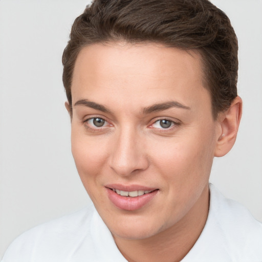 Joyful white young-adult female with short  brown hair and brown eyes