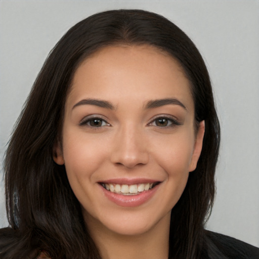 Joyful white young-adult female with long  brown hair and brown eyes