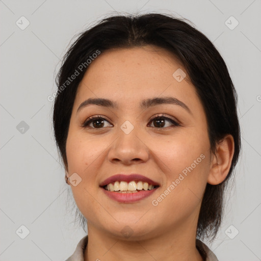 Joyful latino young-adult female with medium  brown hair and brown eyes