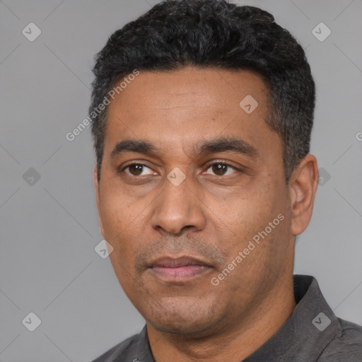 Neutral latino adult male with short  black hair and brown eyes