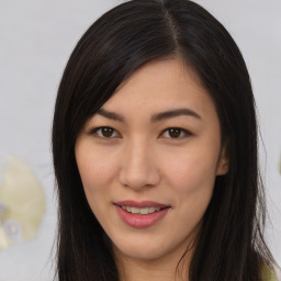 Joyful asian young-adult female with long  brown hair and brown eyes