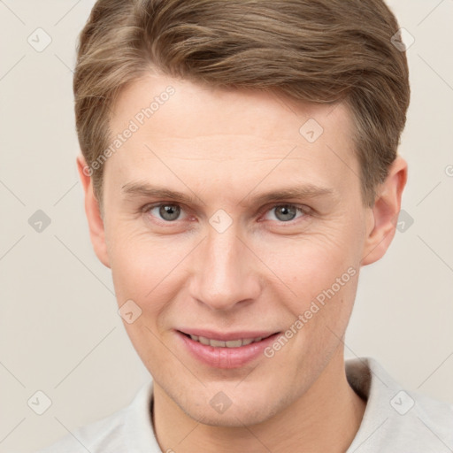 Joyful white adult male with short  brown hair and grey eyes