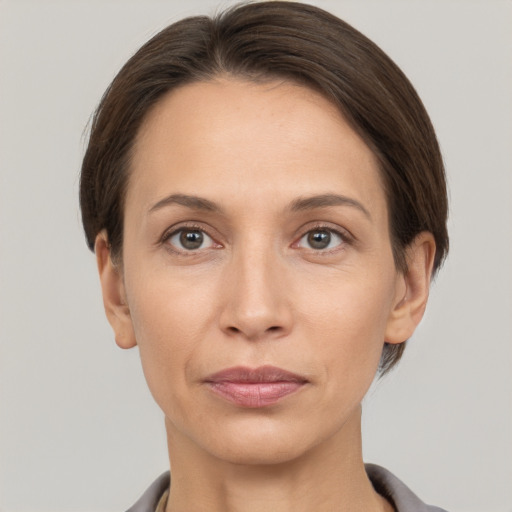 Joyful white adult female with short  brown hair and brown eyes