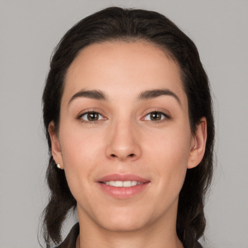 Joyful white young-adult female with long  brown hair and brown eyes