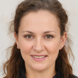 Joyful white adult female with long  brown hair and brown eyes